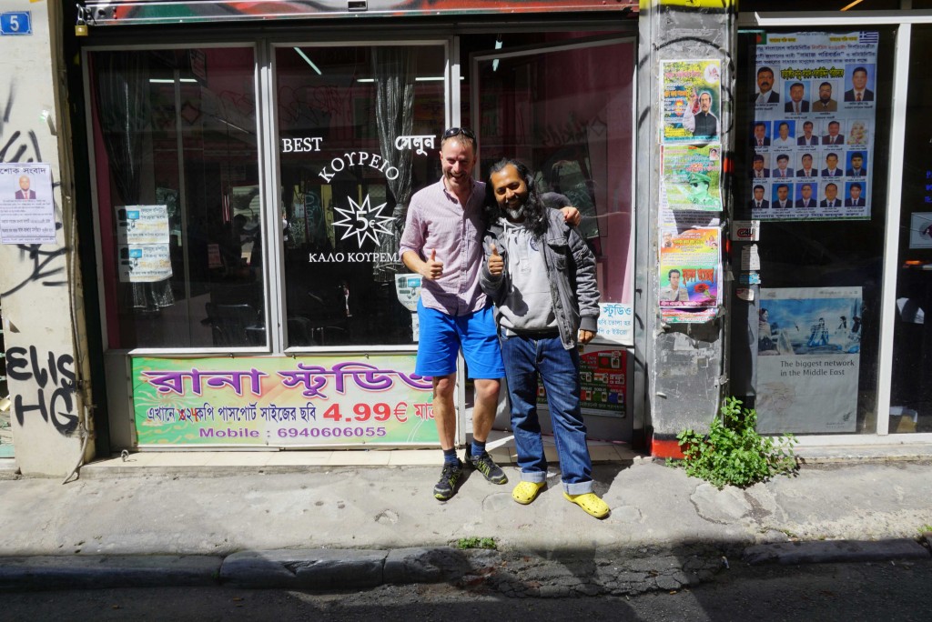 With Rony, also a Warmshowers host, at his barber shop in Athens.