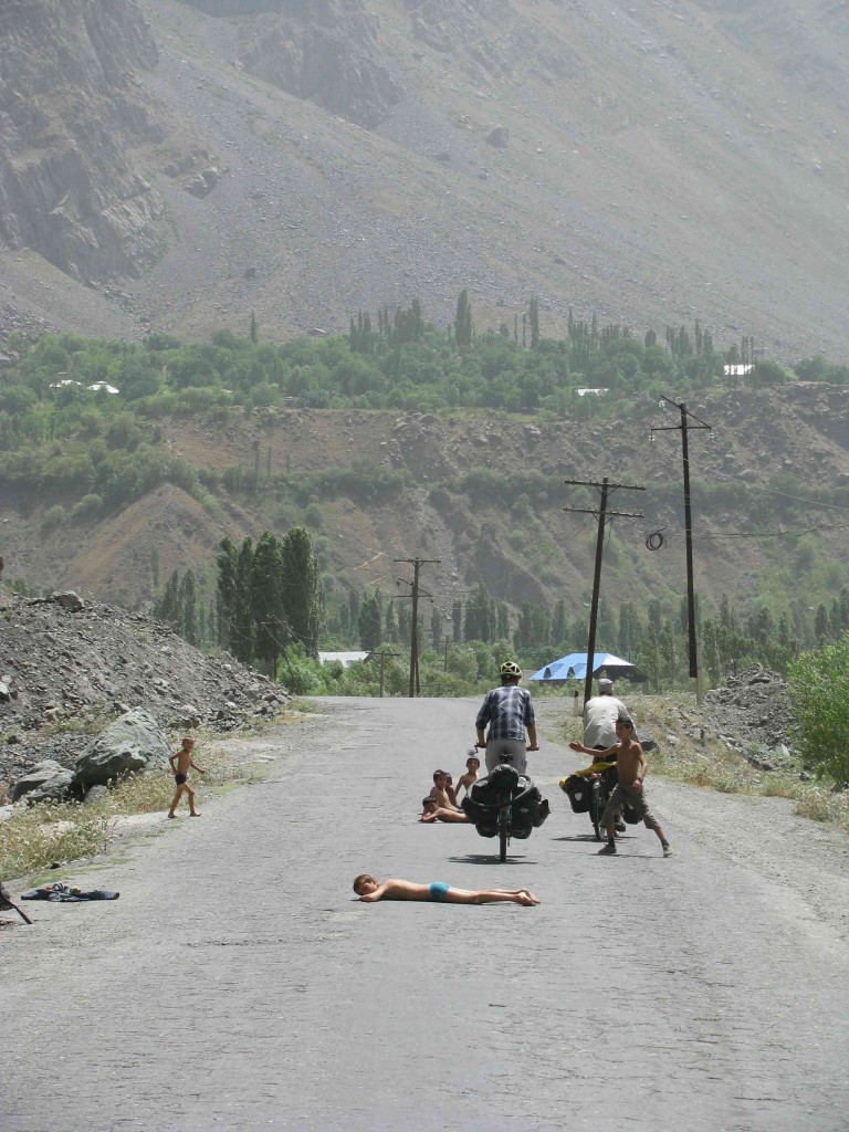 Obstacles take all kinds of unexpected forms in Tajikistan. Wherever there was water, there was usually a pack of bare-ass kids splashing about or drying off. This lot prefered to sun themselves in the middle of the road. Photo credit: R.Holtman