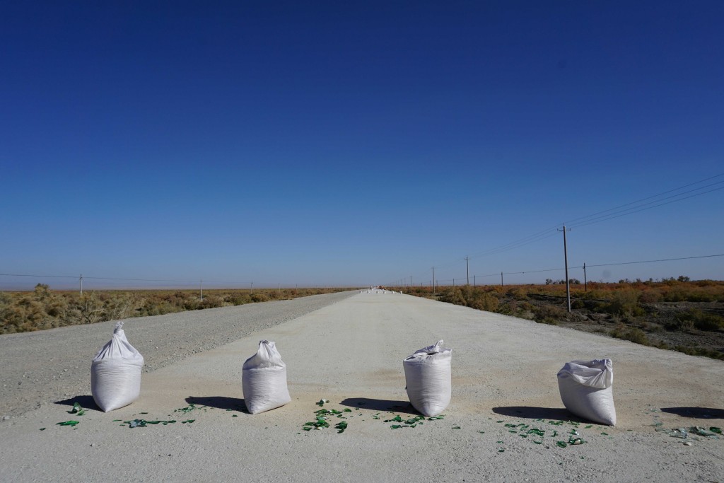 A dirty trick to prevent cycling on the new road deck, approaching Dunhuang, Gansu.