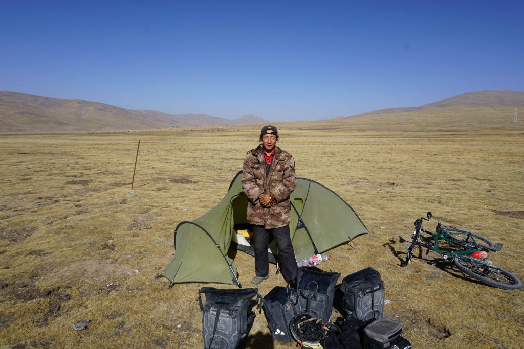 Tibetan yak herder checking out my tent.