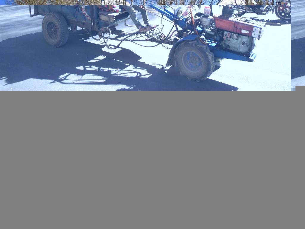 These contraptions were everywhere on the roads in rural Asia. The engine can be hooked up to a plough etc and steered through a field on foot, or coupled with a trailer and driven, as in the photo.